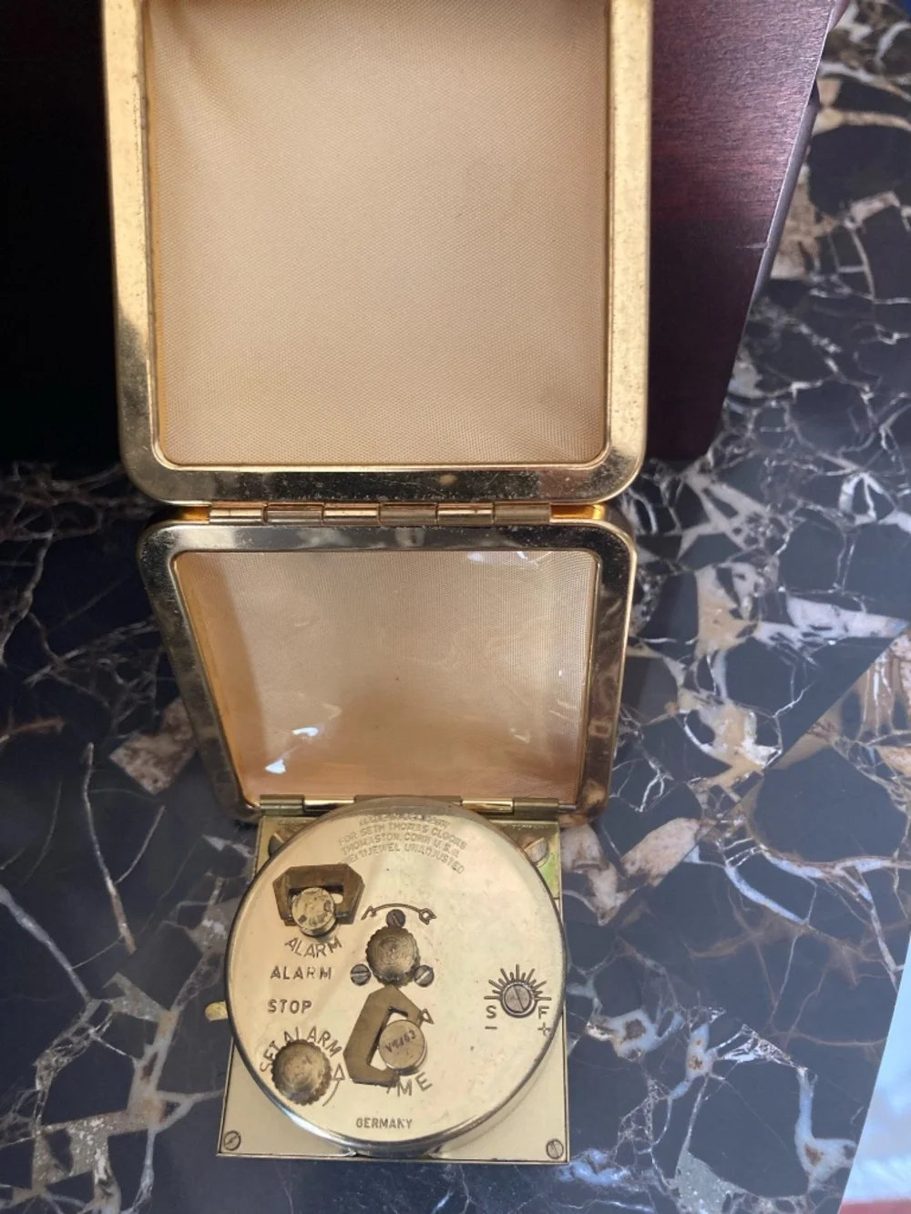 Classic mid-century Seth Thomas folding travel alarm clock in gold-tone texture